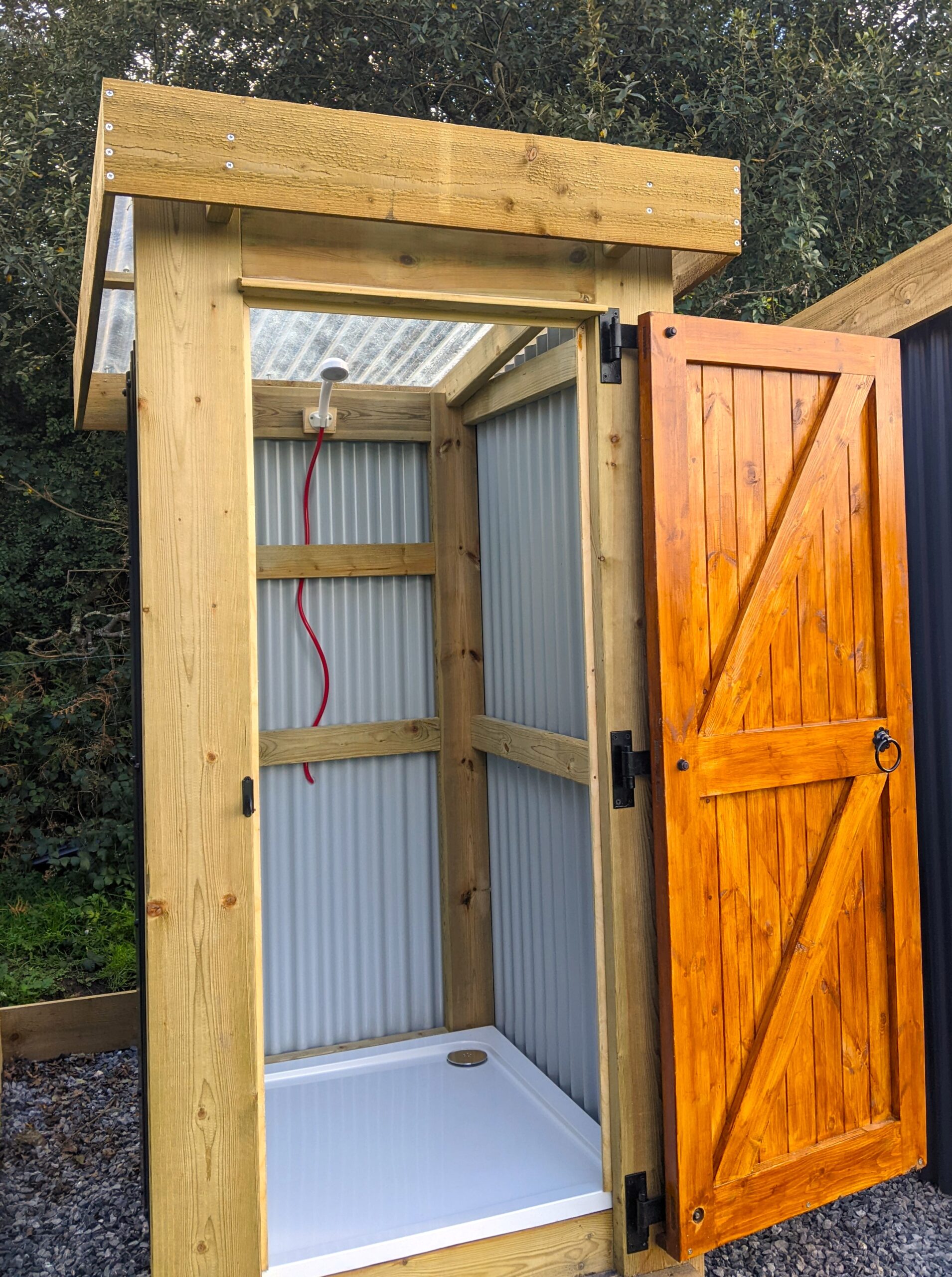 Corrugated finish single depth off grid shower unit with shower tray and stained door