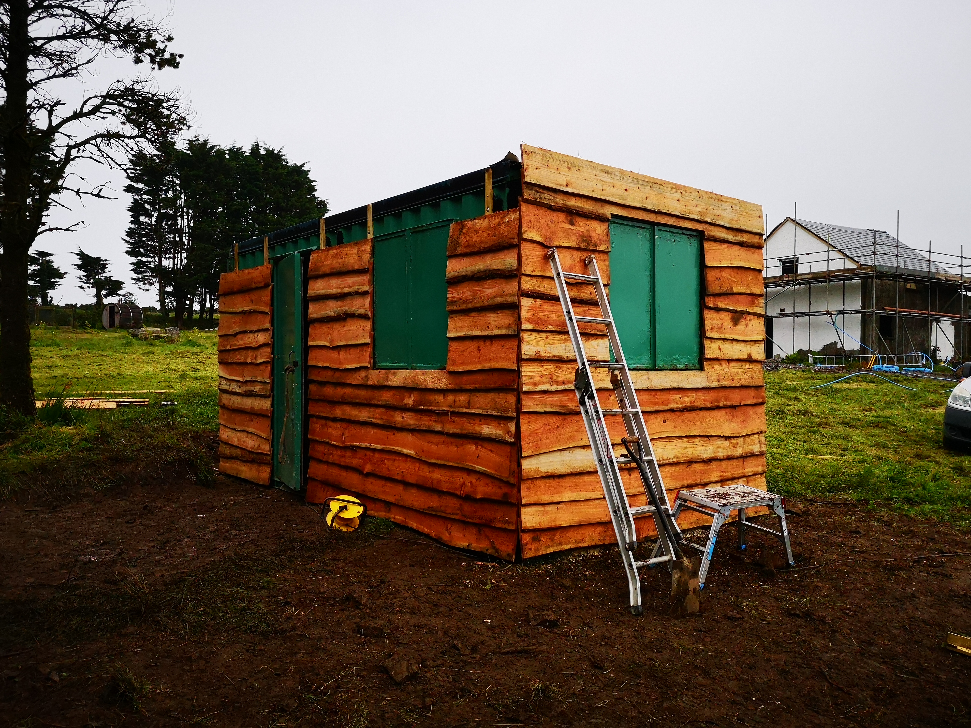 Office shipping container clad with larch waney edge timber